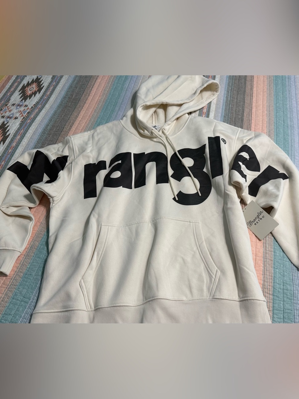 Women’s Wrangler Cream Pullover Hoodie with Black Logo.